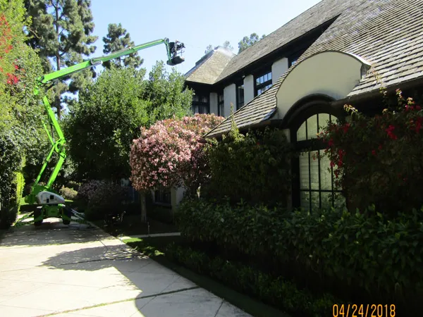 Roof cleaning using elevated access equipment