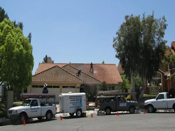 Roof cleaning work on tile roofing