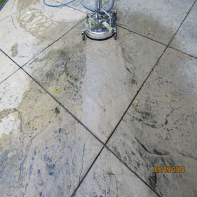 Concrete driveway surface cleaning in progress