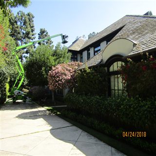 Lift access positioned beside a home for roof cleaning work