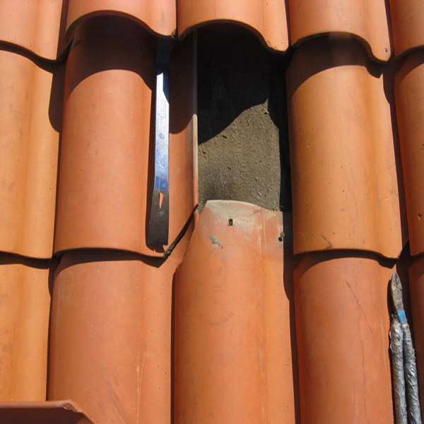 Roof tile repair detail found during exterior cleaning work
