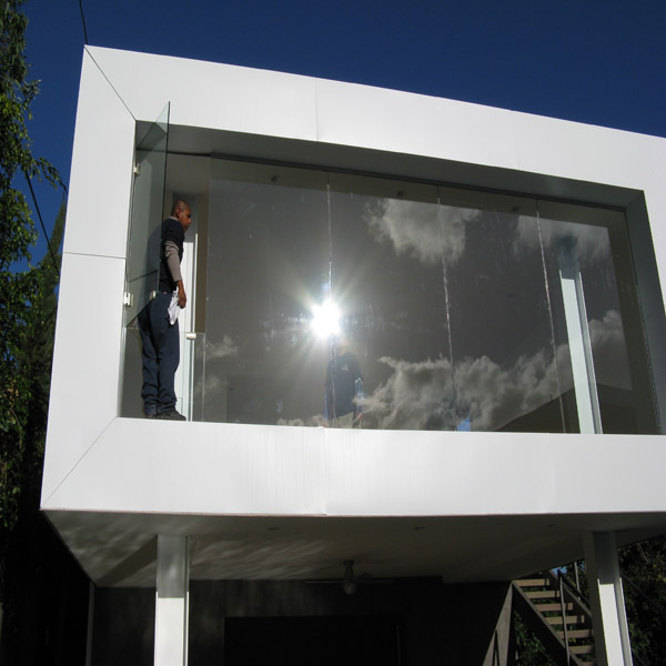 Exterior window cleaning service on a modern home